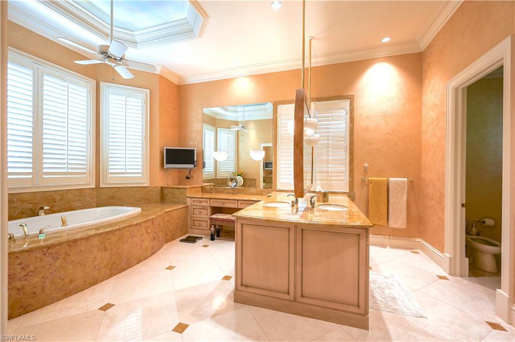 683 Hickory Road Naples, FL 34108 - Photo 23 of 42 a large bathroom with a large tub and sink