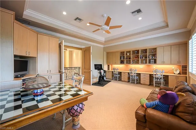 a spacious bedroom with two beds and painting on the wall