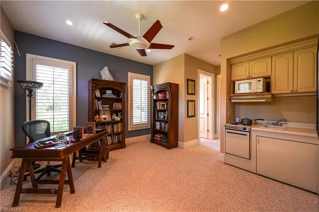 a view of a livingroom with workspace and a window