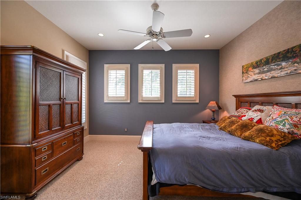 683 Hickory Road Naples, FL 34108 - Photo 34 of 42 a bed room with a bed and a chandelier