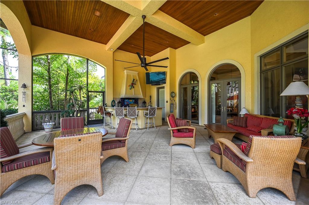 683 Hickory Road Naples, FL 34108 - Photo 36 of 42 a outdoor living space with furniture and a fireplace