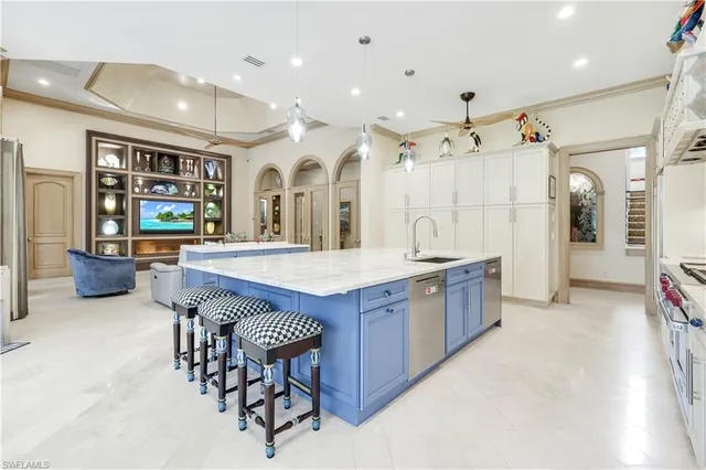 a large kitchen with a table and chairs