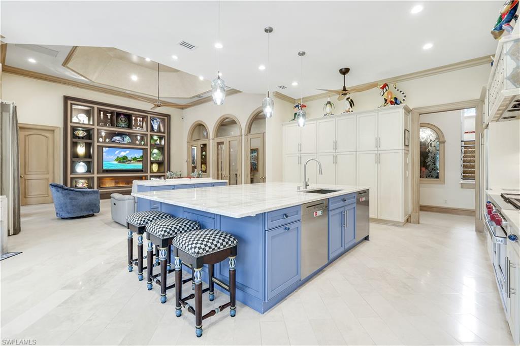 683 Hickory Road Naples, FL 34108 - Photo 7 of 42 a large kitchen with a table and chairs
