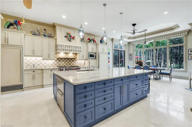 a kitchen with granite countertop a sink and a refrigerator