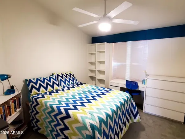 a bedroom with a bed and a cabinet