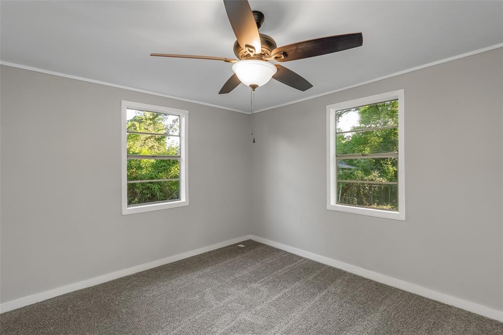 224 Prysock Road Doyline, LA 71023 - Photo 13 of 39 Carpeted empty room with crown molding, plenty of natural light, and a ceiling fan
