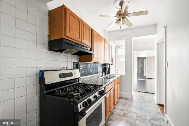 a kitchen with stainless steel appliances granite countertop a stove a sink dishwasher and a refrigerator