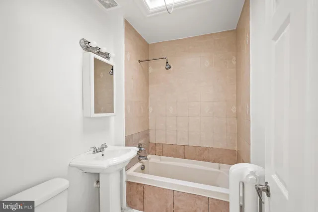 a white bath tub sitting next to a white sink