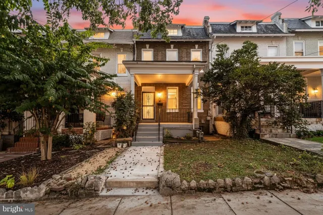 a front view of a house with a garden
