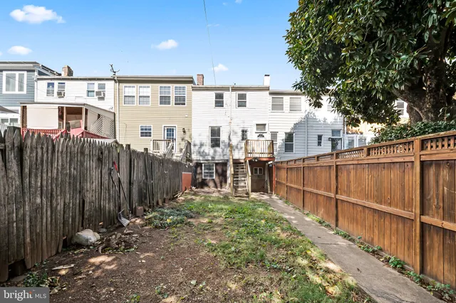 a view of a house with wooden fence