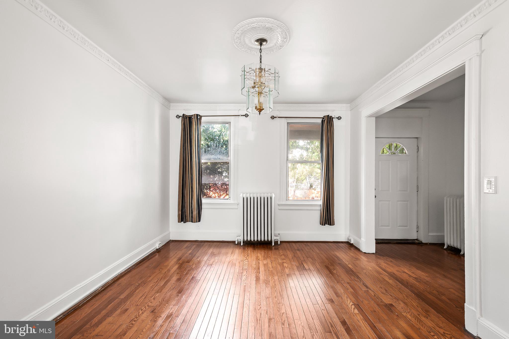 1214 Kennedy Street Northwest Washington, DC 20011 - Photo 5 of 34 an empty room with wooden floor and windows