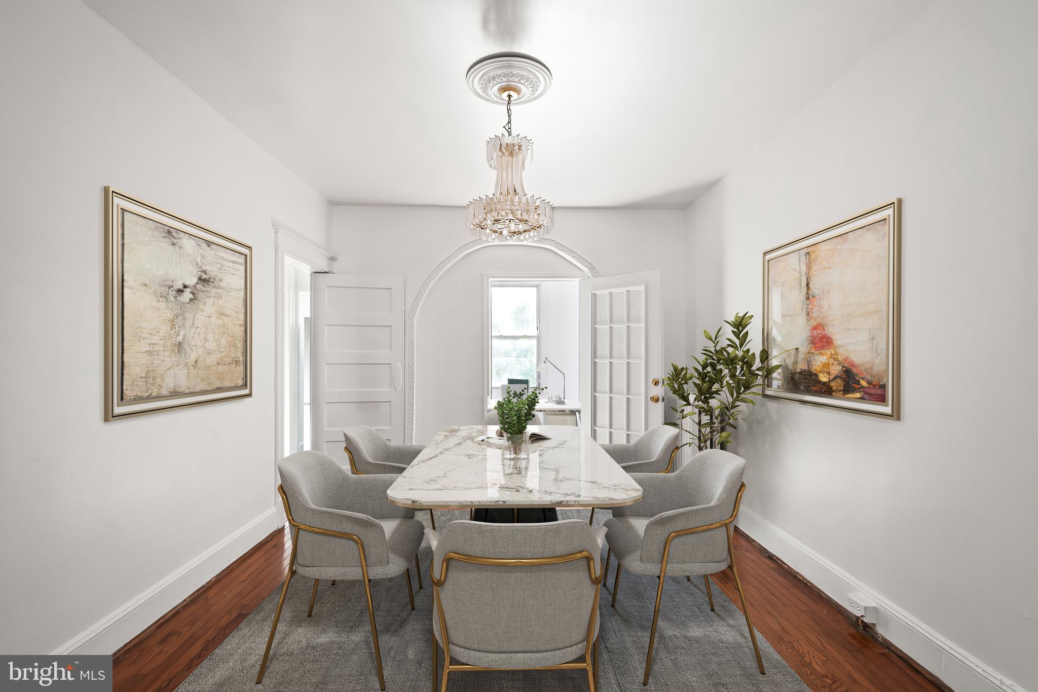 1214 Kennedy Street Northwest Washington, DC 20011 - Photo 9 of 34 a dining room with furniture a potted plant and a chandelier