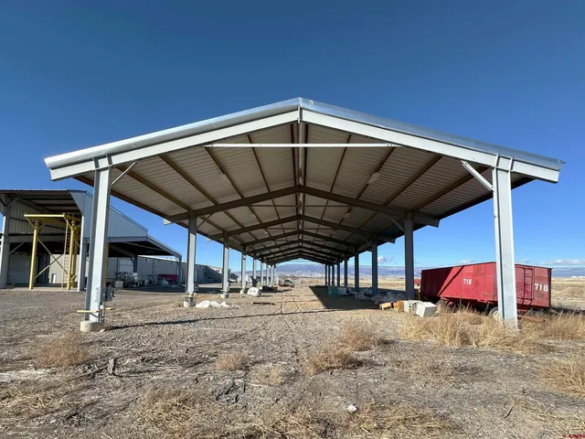 a view of a car park with large trees