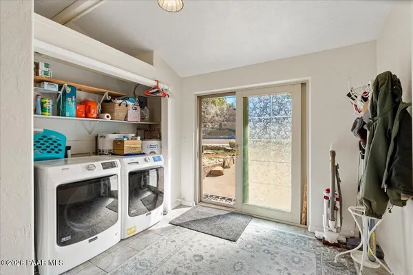 a livingroom with fridge dryer and washer