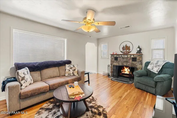 a living room with furniture a fireplace and a large mirror