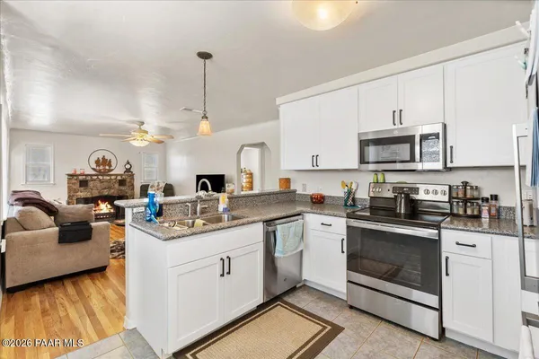a kitchen with a sink stove and cabinets