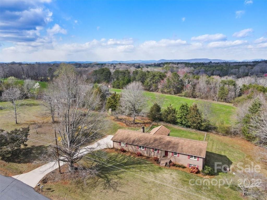a view of a yard with wooden fence
