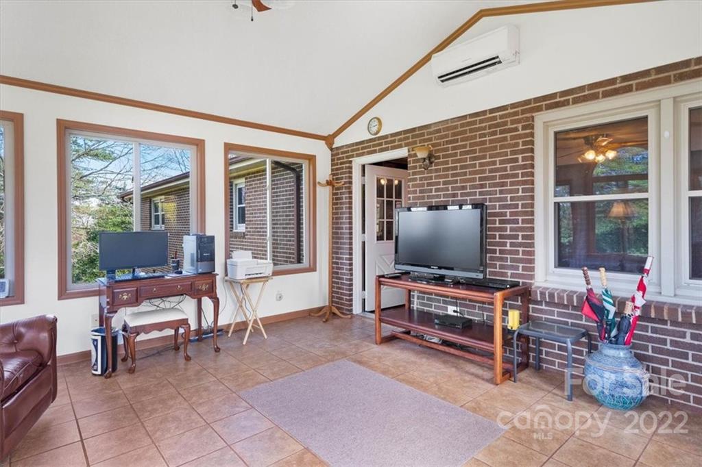 1552 Allen Lane Conover, NC 28613 - Photo 11 of 38 a living room with furniture a flat screen tv and floor to ceiling window