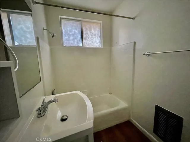a bathroom with a tub and sink