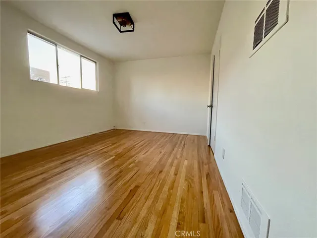 a view of a room with wooden floor and window