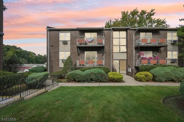 a view of a house with a small yard and a garden