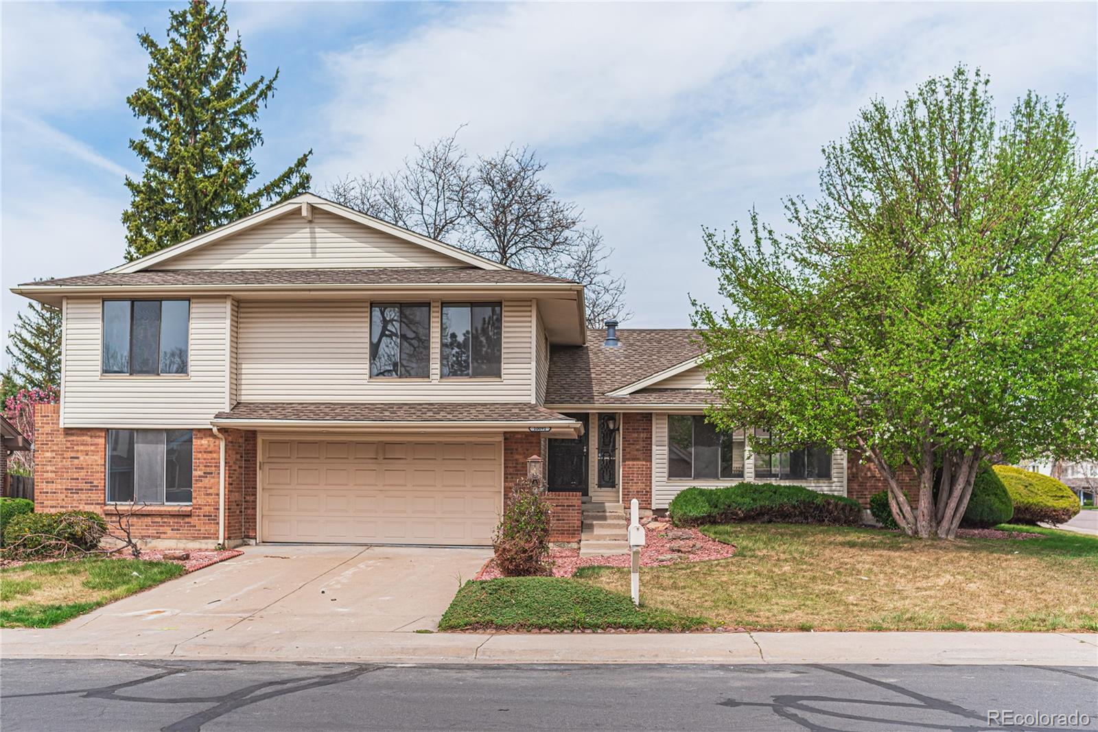 10091 Yates Street Westminster, CO 80031 - Photo 1 of 40 a front view of a house with a garden