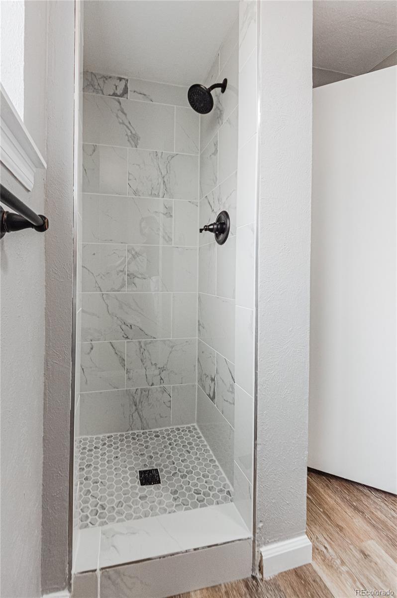 10091 Yates Street Westminster, CO 80031 - Photo 19 of 40 a bathroom with a shower