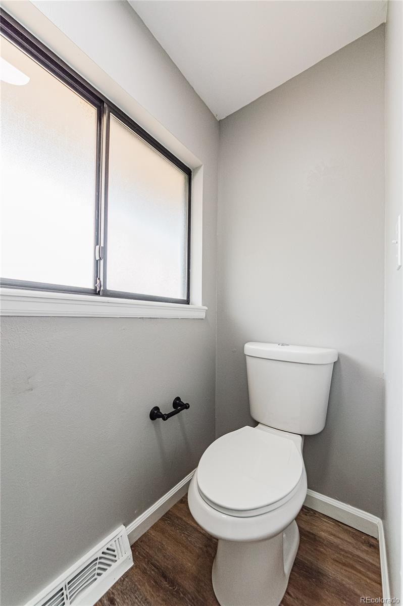 10091 Yates Street Westminster, CO 80031 - Photo 24 of 40 a bathroom with a toilet and a window