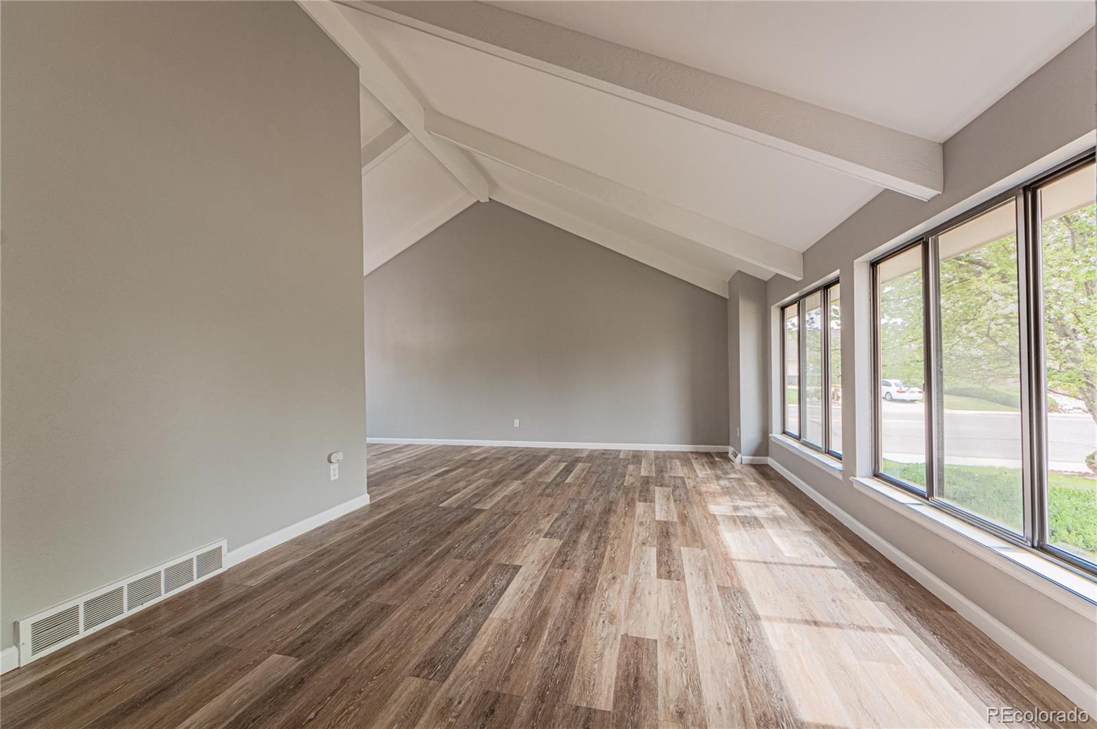 10091 Yates Street Westminster, CO 80031 - Photo 5 of 40 a view of an empty room with wooden floor and a window