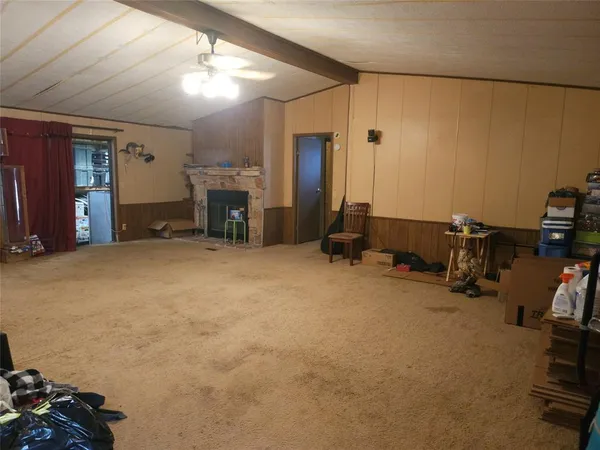a view of a livingroom with furniture and a fan
