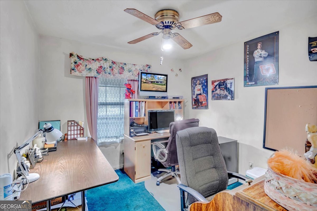 1702 Vada Road Bainbridge, GA 39817 - Photo 7 of 33 a workspace with furniture and a wooden floor