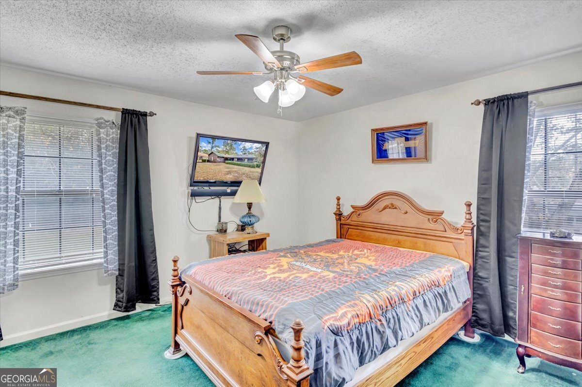 1702 Vada Road Bainbridge, GA 39817 - Photo 8 of 33 a bedroom with a bed and a large window