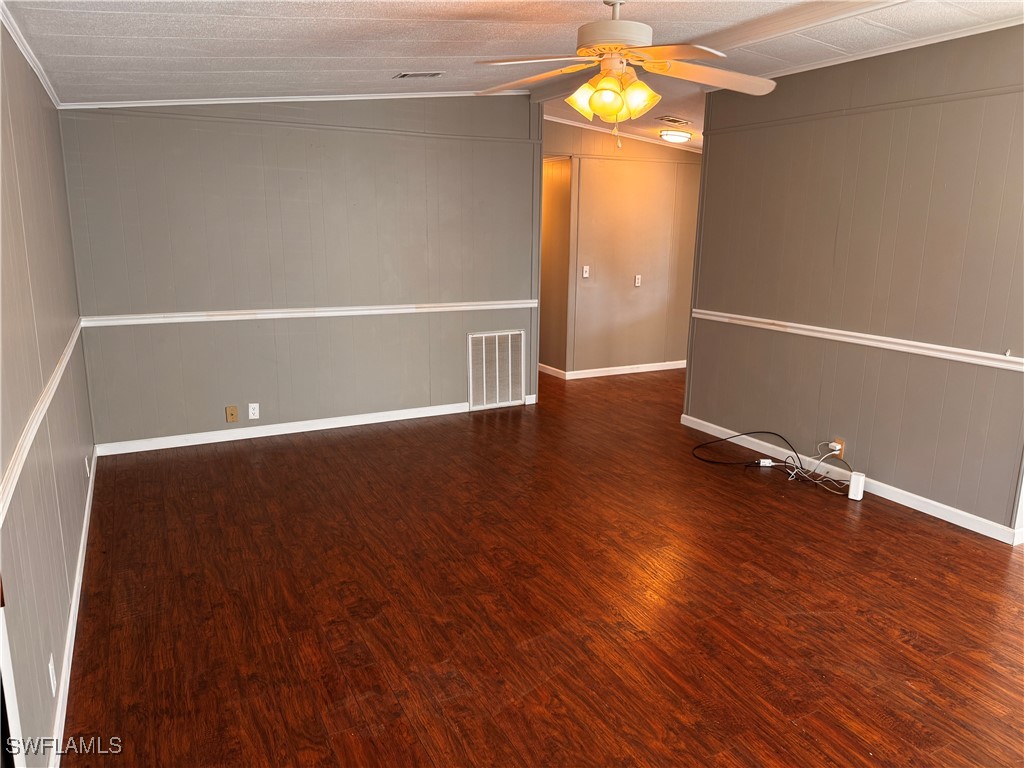 15550 Burnt Store Road, Unit 228 Punta Gorda, FL 33955 - Photo 15 of 40 a view of an empty room with wooden floor and a window