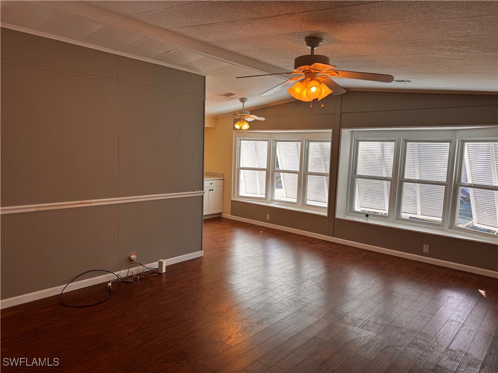 15550 Burnt Store Road, Unit 228 Punta Gorda, FL 33955 - Photo 17 of 40 an empty room with wooden floor and windows