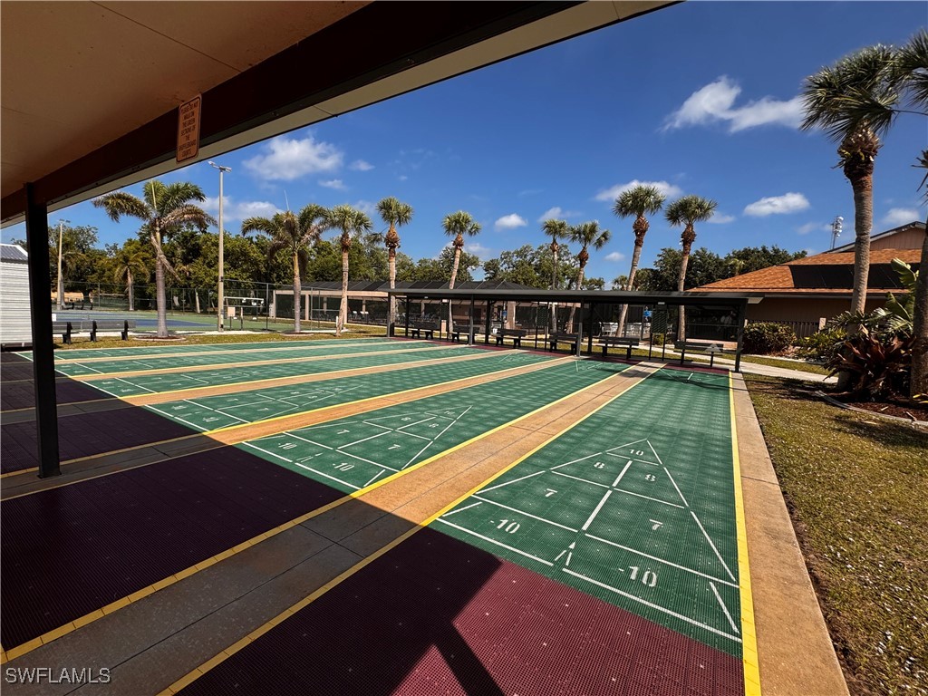 15550 Burnt Store Road, Unit 228 Punta Gorda, FL 33955 - Photo 26 of 40 a view of a tennis ground with large trees