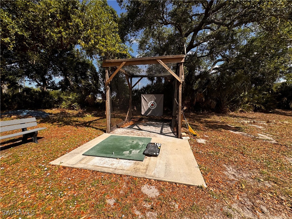 15550 Burnt Store Road, Unit 228 Punta Gorda, FL 33955 - Photo 30 of 40 a view of a patio with a table and chairs under an umbrella