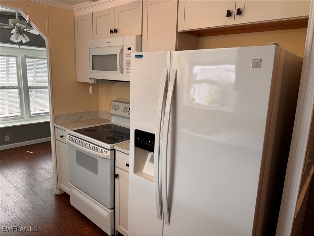 15550 Burnt Store Road, Unit 228 Punta Gorda, FL 33955 - Photo 3 of 40 a kitchen with white cabinets and white appliances