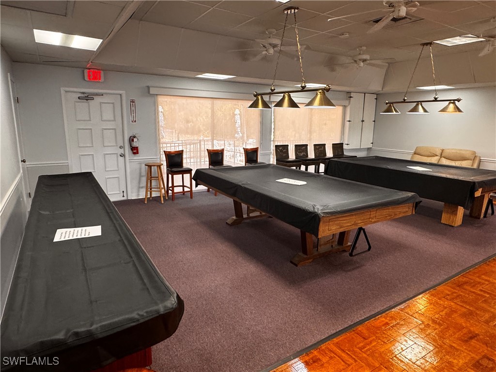 15550 Burnt Store Road, Unit 228 Punta Gorda, FL 33955 - Photo 35 of 40 a living room with lots of furniture and a rug