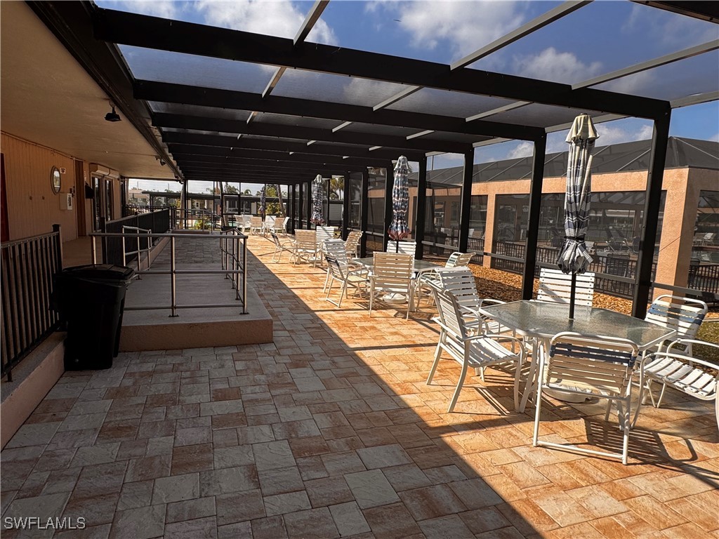 15550 Burnt Store Road, Unit 228 Punta Gorda, FL 33955 - Photo 38 of 40 a view of a patio with table and chairs stove and glass door
