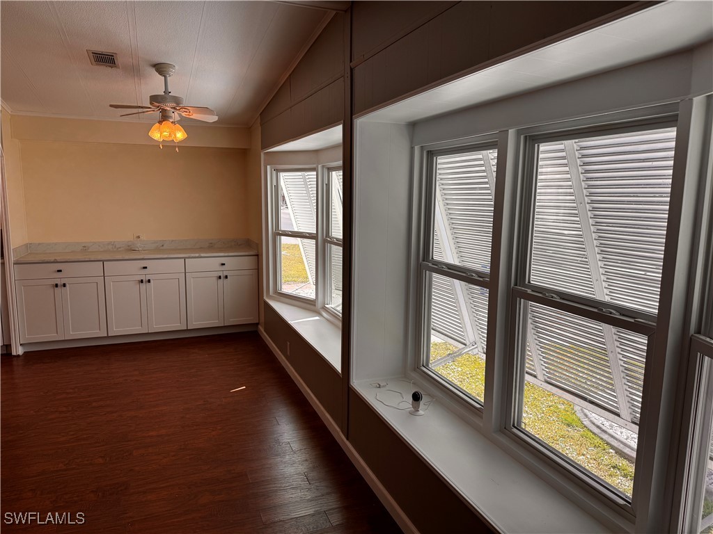 15550 Burnt Store Road, Unit 228 Punta Gorda, FL 33955 - Photo 4 of 40 a view of an empty room with window and wooden floor