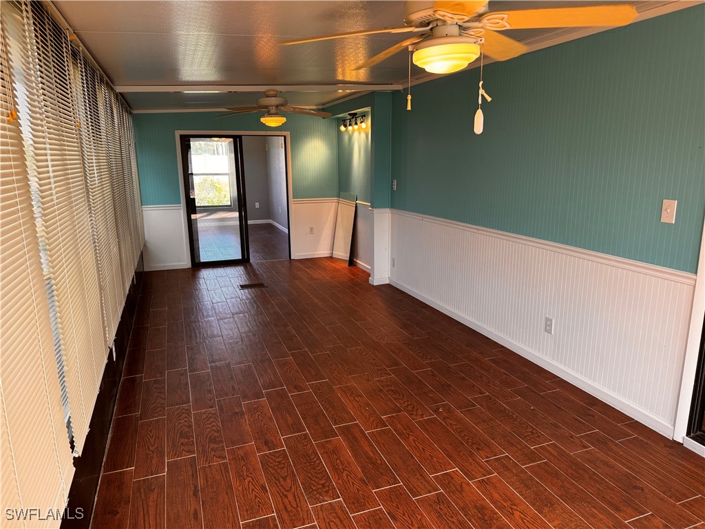 15550 Burnt Store Road, Unit 228 Punta Gorda, FL 33955 - Photo 5 of 40 a view of an empty room with window and wooden floor