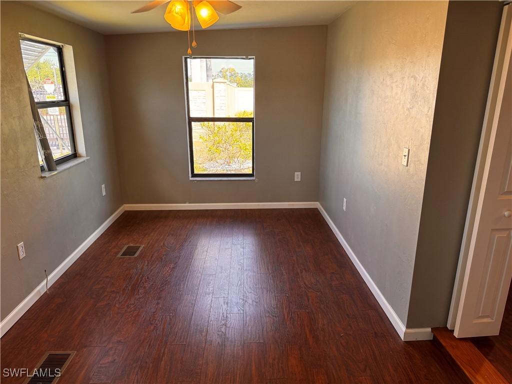 15550 Burnt Store Road, Unit 228 Punta Gorda, FL 33955 - Photo 6 of 40 an empty room with wooden floor and windows