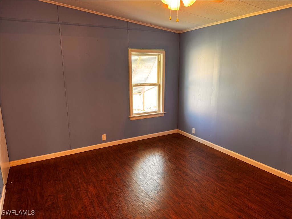 15550 Burnt Store Road, Unit 228 Punta Gorda, FL 33955 - Photo 7 of 40 an empty room with wooden floor and windows