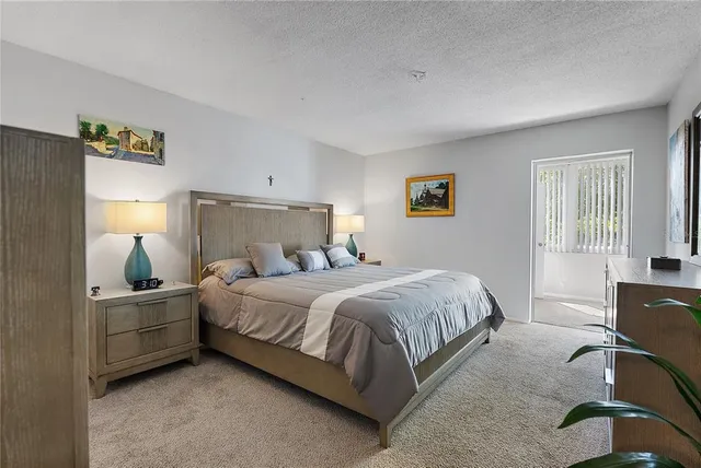 a bedroom with a bed and lamp