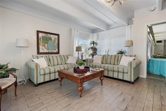 a dining room with furniture and a kitchen view
