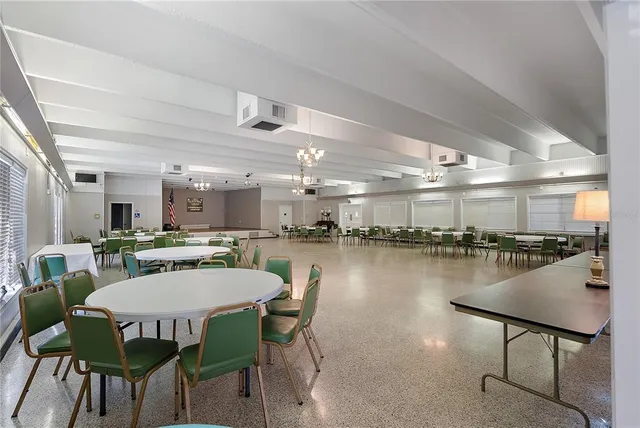 a kitchen with granite countertop white cabinets white appliances a sink and a window