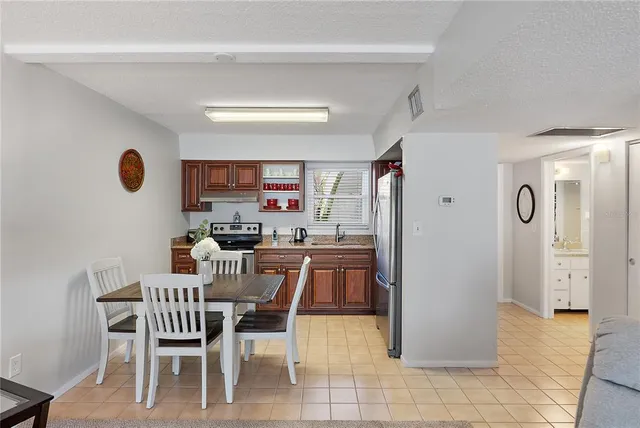 a view of a dining room with furniture and a chandelier