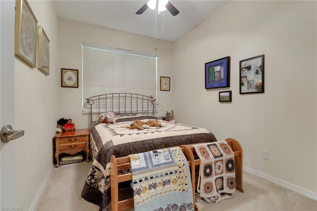 14174 Danpark Loop Fort Myers, FL 33912 - Photo 12 of 20 a bedroom with a bed and a chandelier