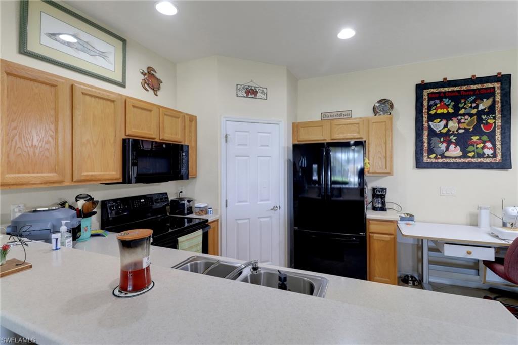 14174 Danpark Loop Fort Myers, FL 33912 - Photo 7 of 20 a kitchen with a refrigerator and a stove top oven