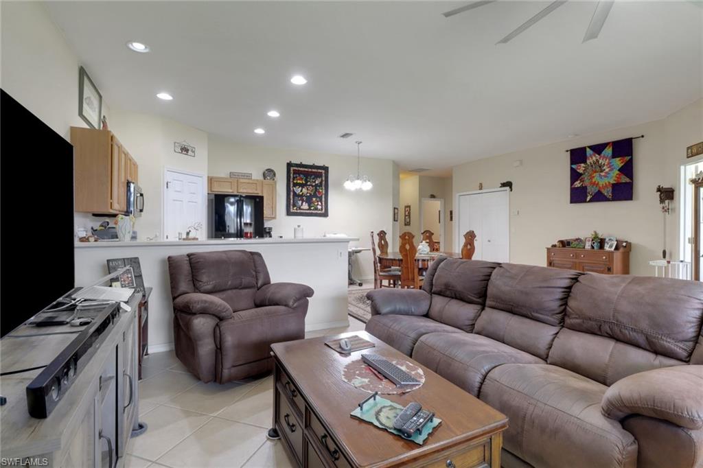 14174 Danpark Loop Fort Myers, FL 33912 - Photo 10 of 20 a living room with furniture kitchen and a flat screen tv